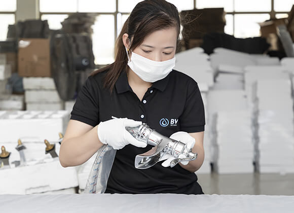 a female worker conducting finished faucet inspection